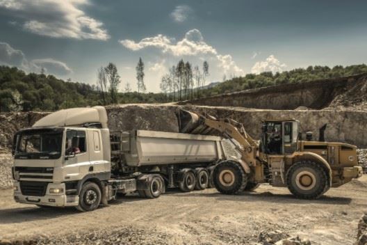 construction truck being filled with gravel