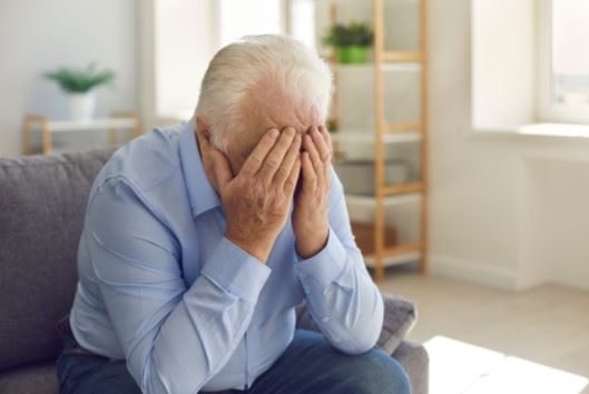 elderly man grieving the loss of a loved one